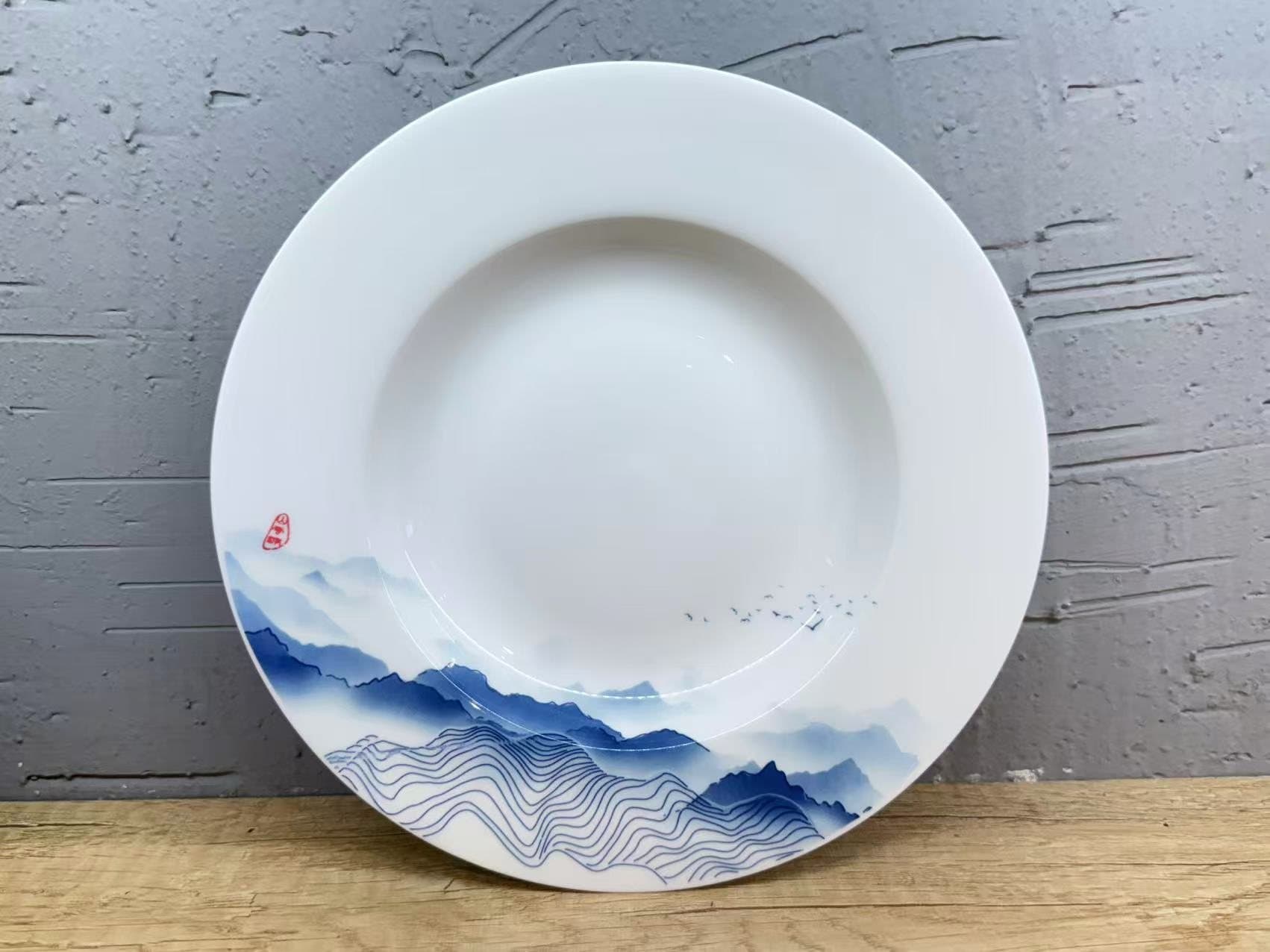 A shan-shui landscape carried across every piece.