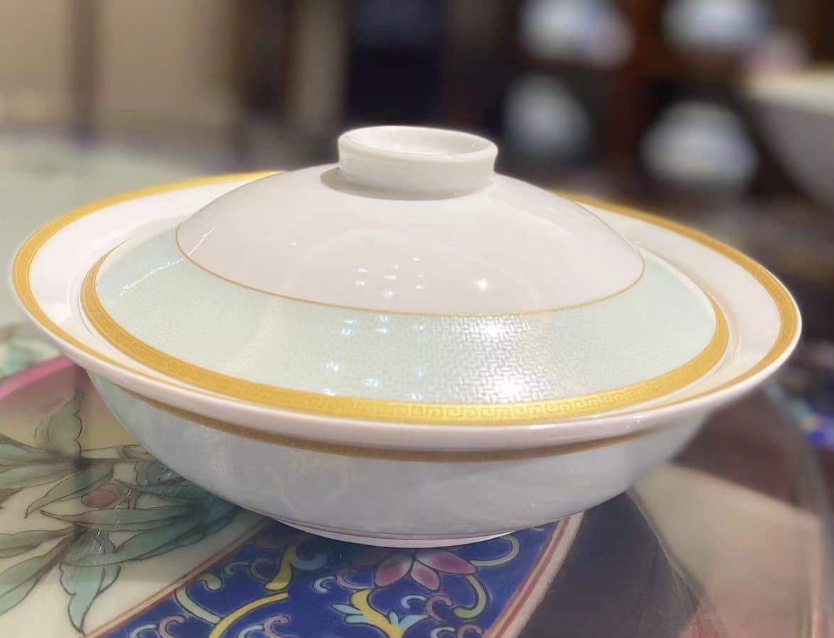 The Gilded Ocean 28-piece family service — ocean blues closed with a fine gold rim